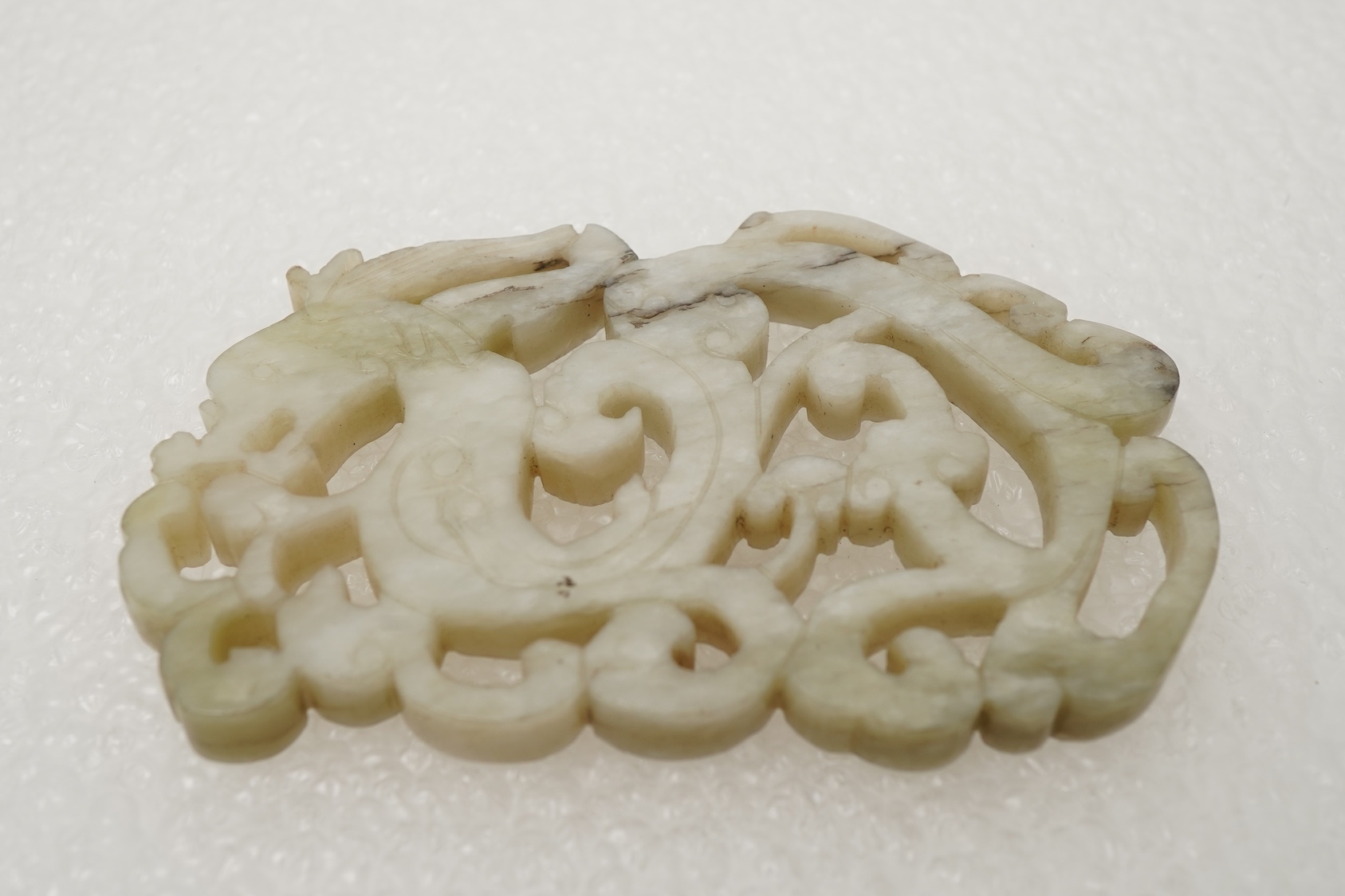 A Chinese white and grey mottled jade ‘chilong’ plaque, Ming dynasty